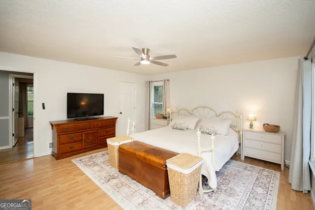 a bedroom with a bed and a flat screen tv