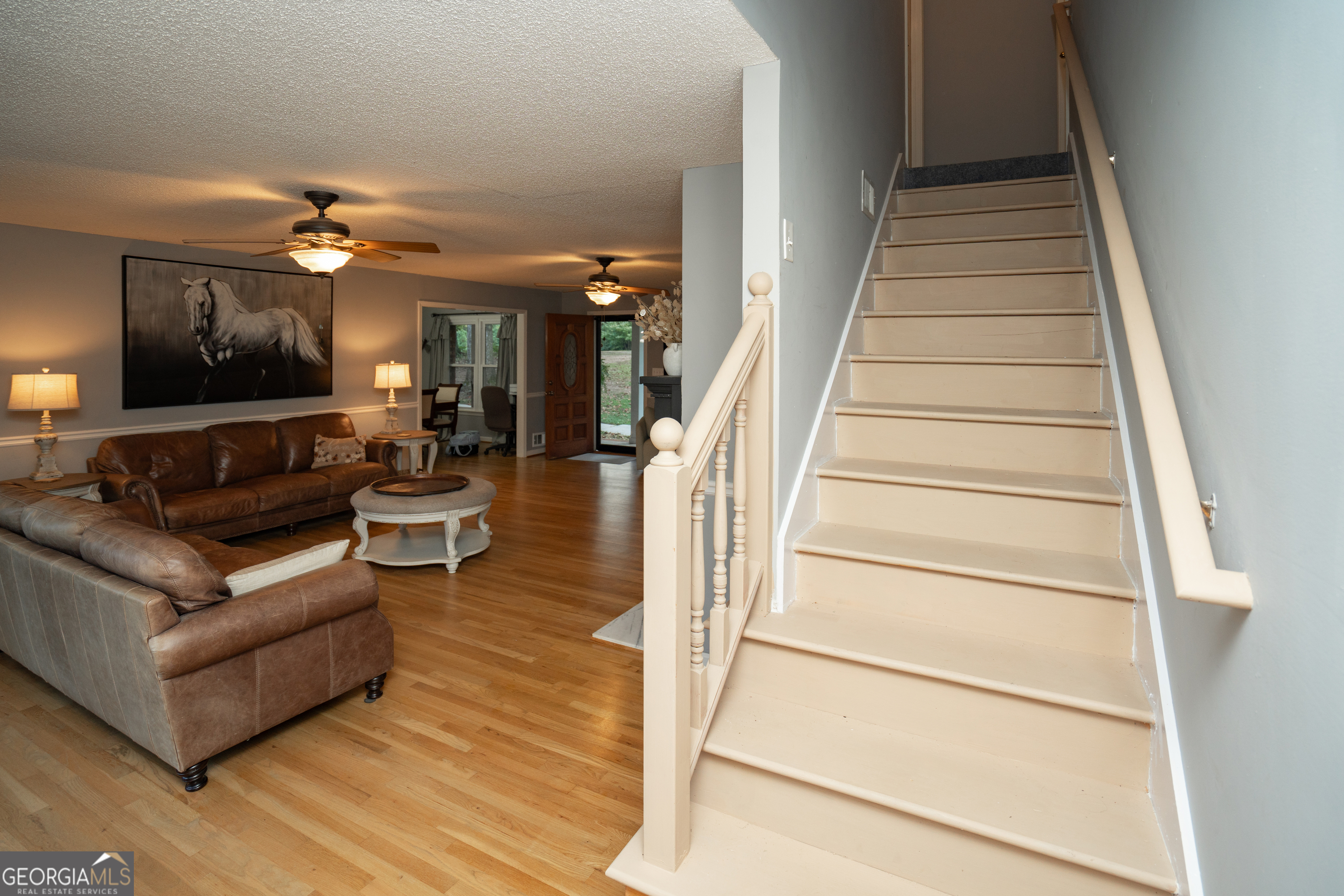 295 Hillview Road Hampton, GA 30228 - Photo 28 of 70 a living room with furniture and a chandelier