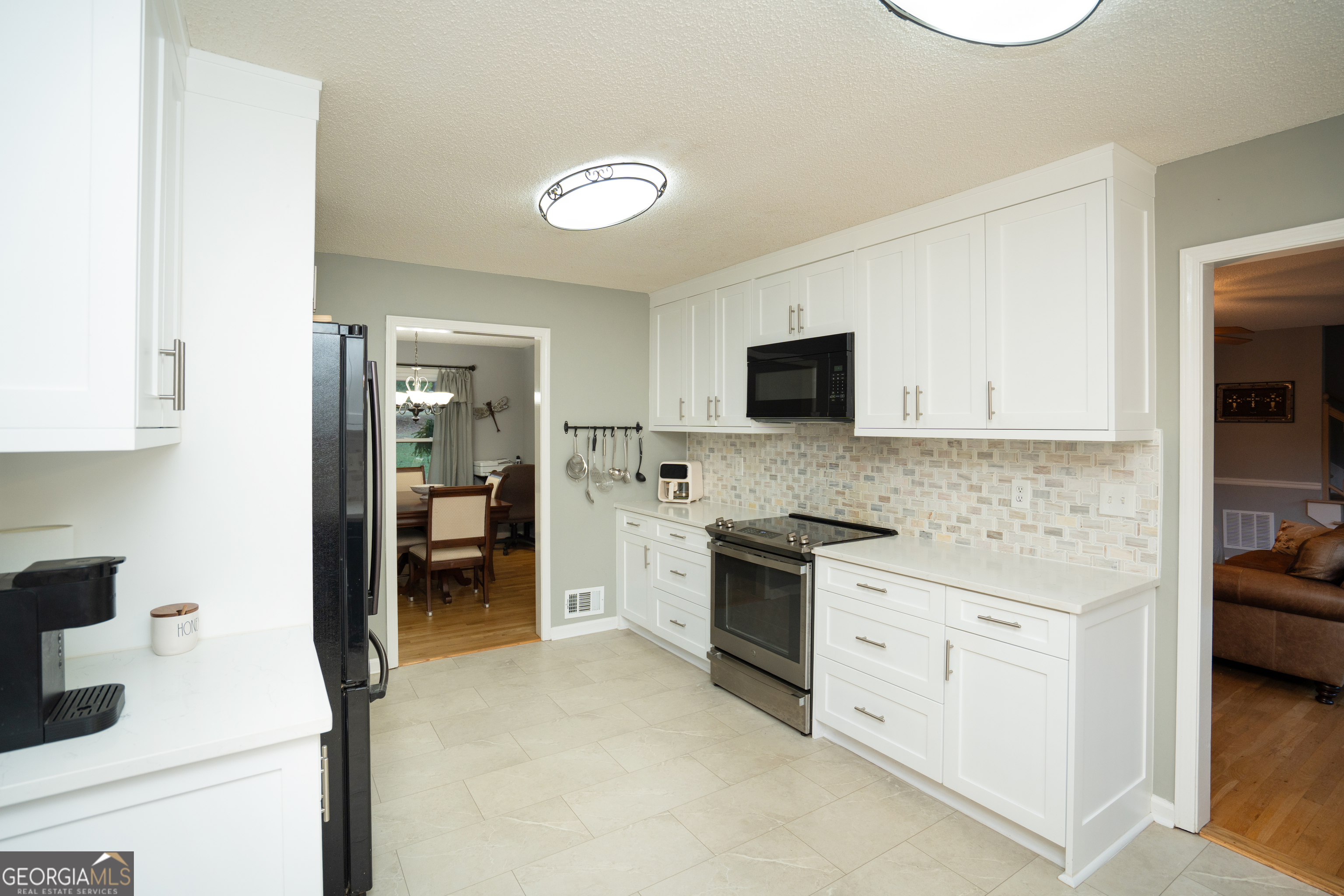 295 Hillview Road Hampton, GA 30228 - Photo 35 of 70 a kitchen with granite countertop a sink stove and cabinets