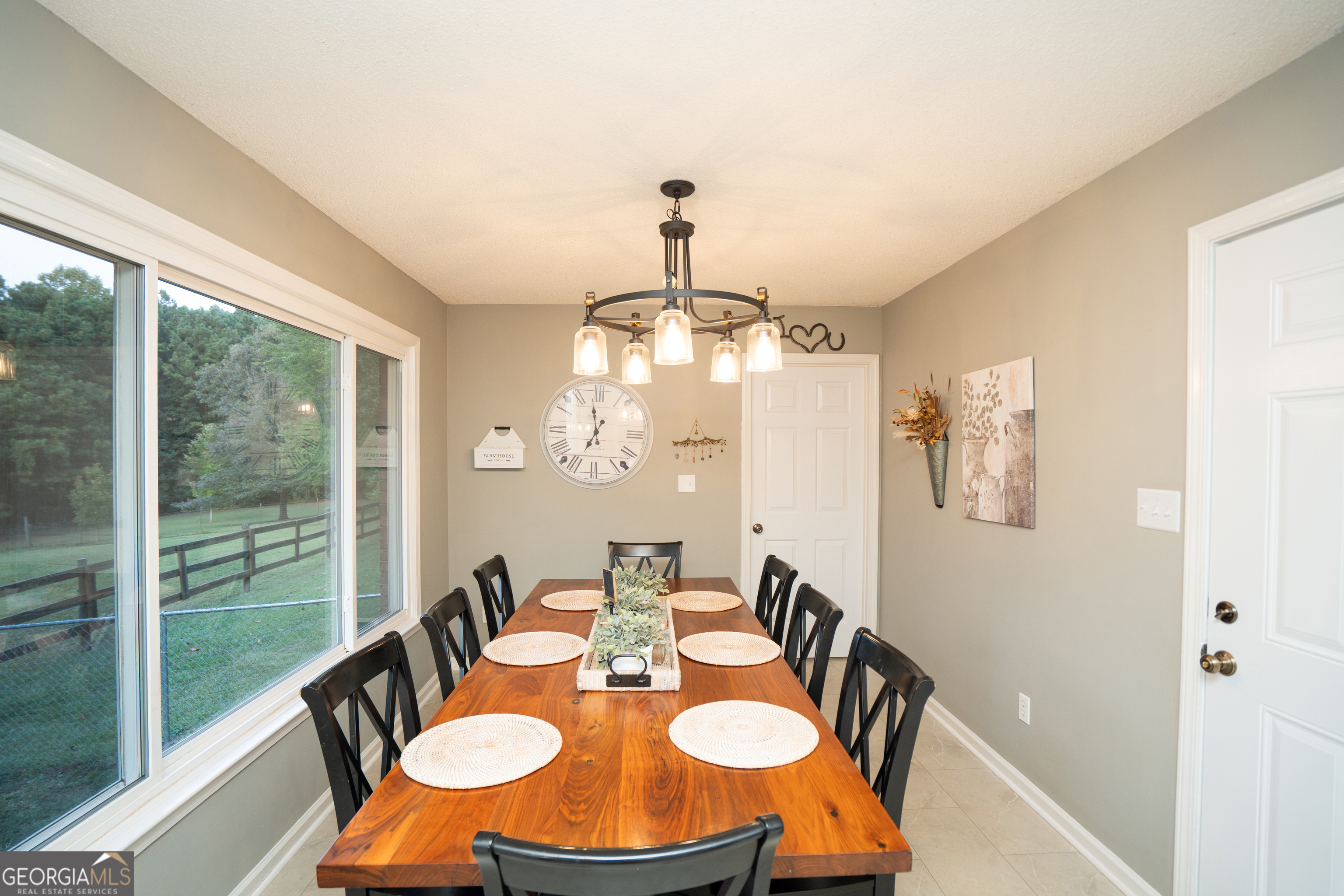 295 Hillview Road Hampton, GA 30228 - Photo 38 of 70 a view of a dining room with furniture a chandelier and large windows