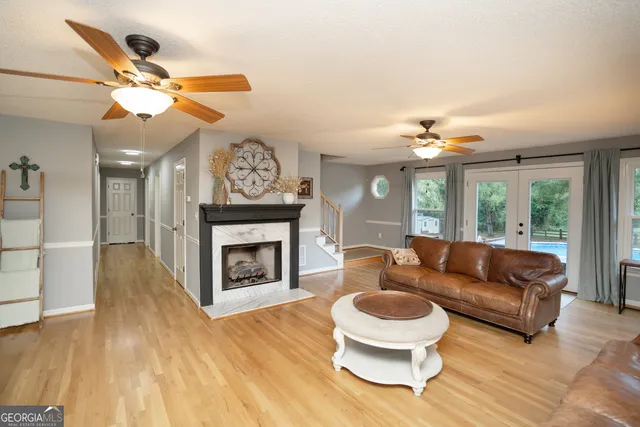 a living room with furniture a fireplace and a chandelier