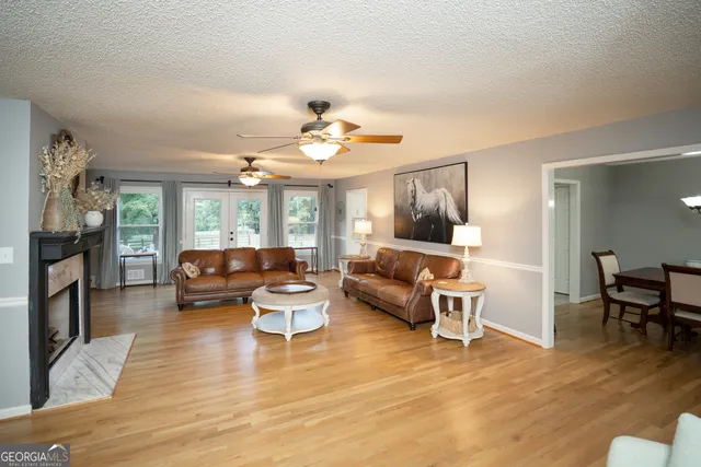 a living room with furniture a fireplace and a flat screen tv