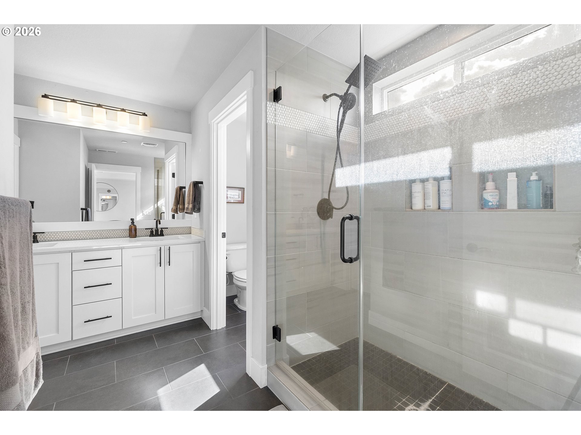 5788 North 86th Circle Camas, WA 98607 - Photo 14 of 26 a bathroom with a shower sink and mirror