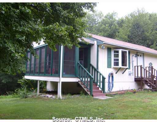 230 Calvin French Road Sterling, CT 06377 - Photo 1 of 1 a view of a house with backyard porch and wooden fence