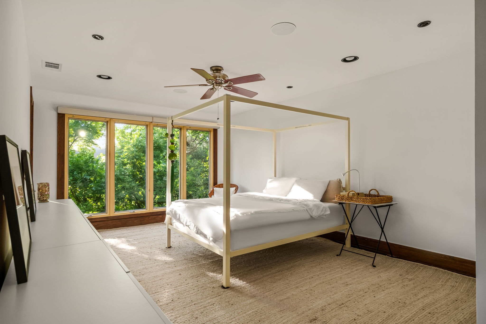 1111 West 12th Street, Unit 107 Austin, TX 78703 - Photo 25 of 38 Room featuring expansive windows with wood trim, a ceiling fan, recessed lighting, and light-toned carpet flooring