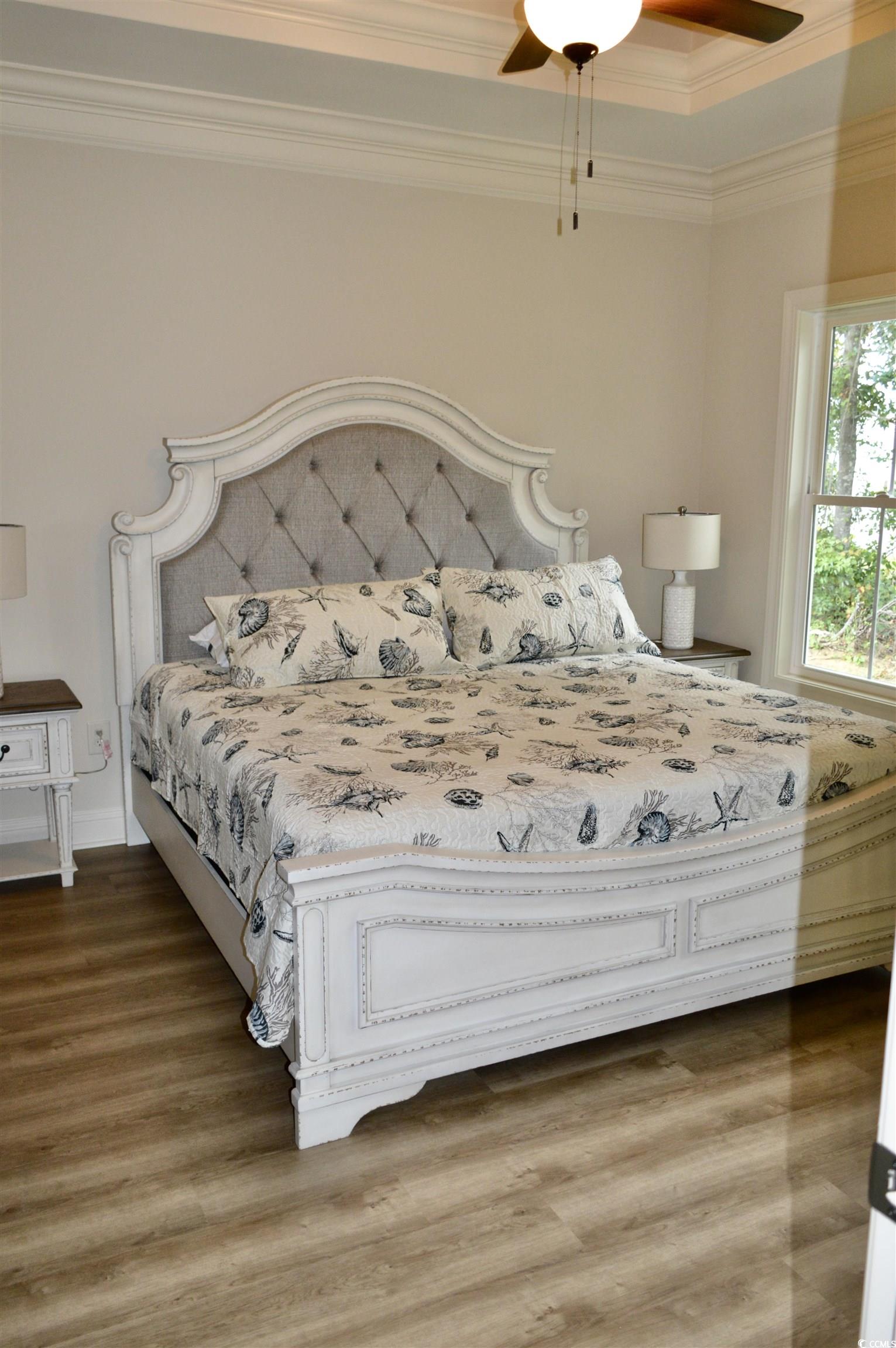 151 Hallandale Lane, Unit LEFT Murrells Inlet, SC 29576 - Photo 11 of 21 Bedroom featuring crown molding, wood finished floors, baseboards, and a ceiling fan