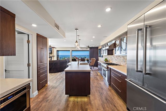 a large kitchen with stainless steel appliances lots of counter top space