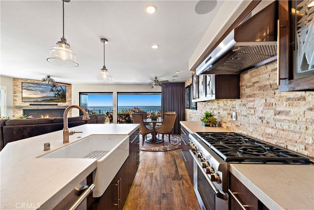 a kitchen with a sink a stove and chairs
