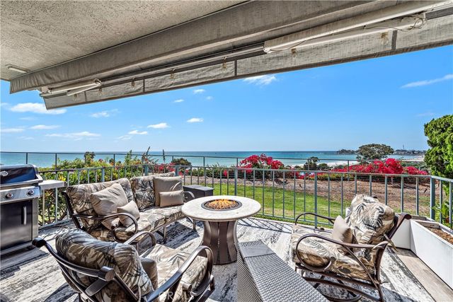 a balcony with furniture and a floor to ceiling window