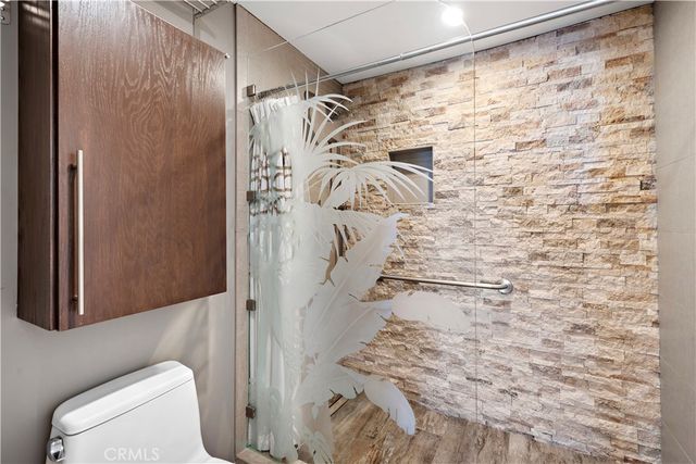 a bathroom with a toilet and shower