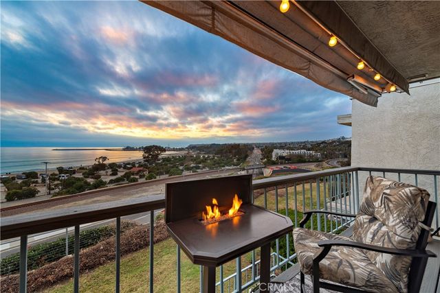 a view of a balcony with mountain view and wooden floor