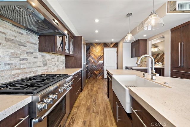a kitchen with sink stove and cabinets