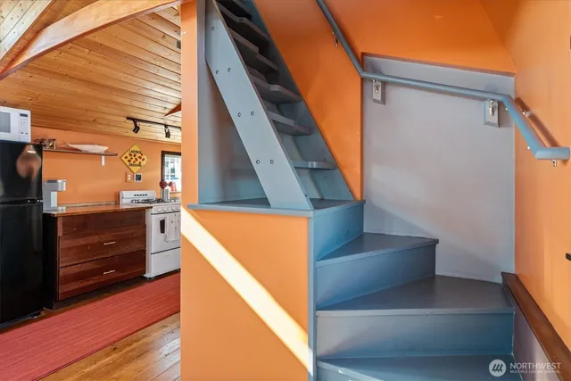 a kitchen with stainless steel appliances granite countertop a refrigerator and a stove