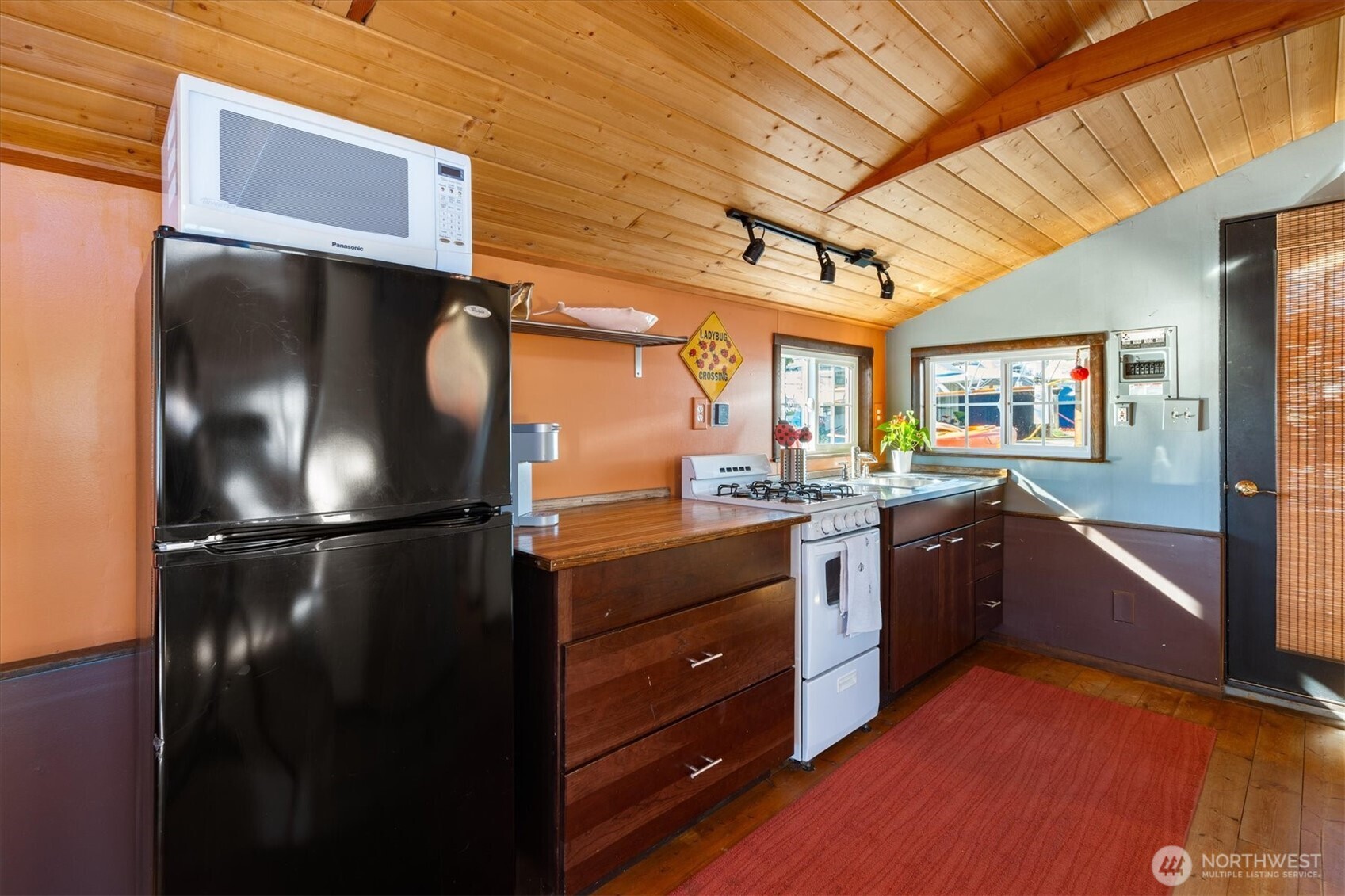 2401 North Northlake Way, Unit L6 Seattle, WA 98103 - Photo 12 of 30 a kitchen with stainless steel appliances granite countertop a refrigerator and a stove