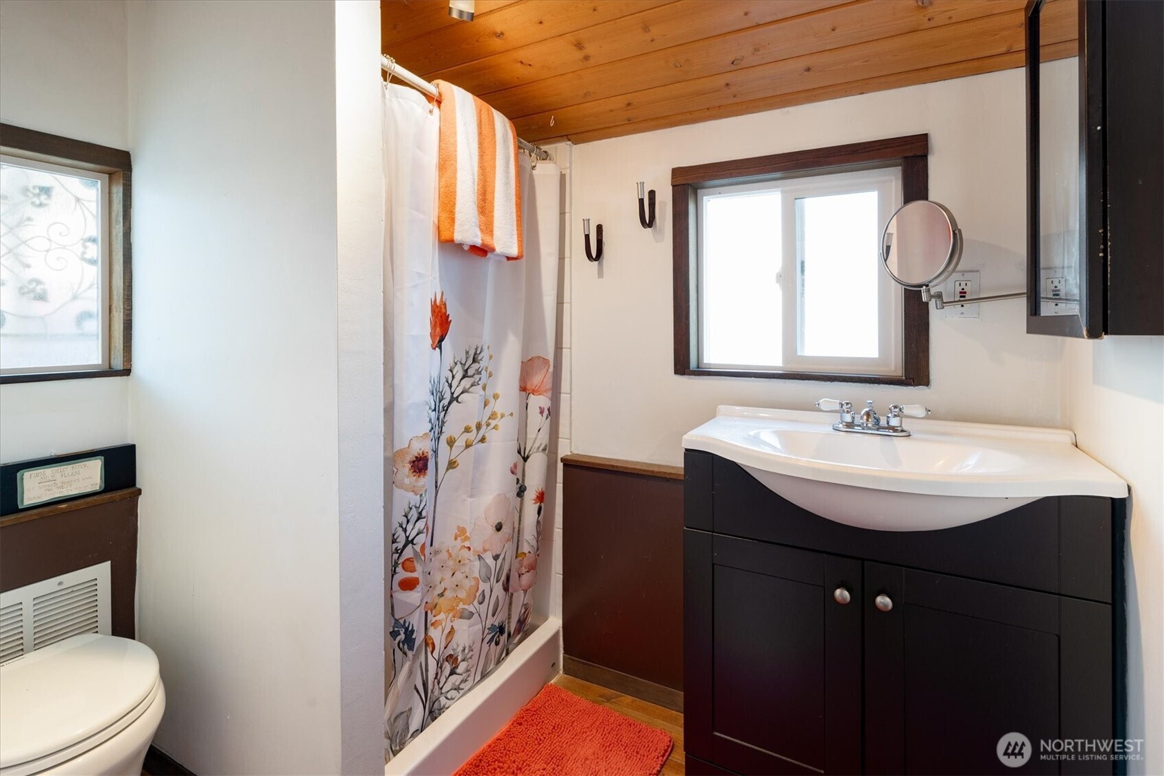 2401 North Northlake Way, Unit L6 Seattle, WA 98103 - Photo 14 of 30 a bathroom with a sink a toilet and shower curtain