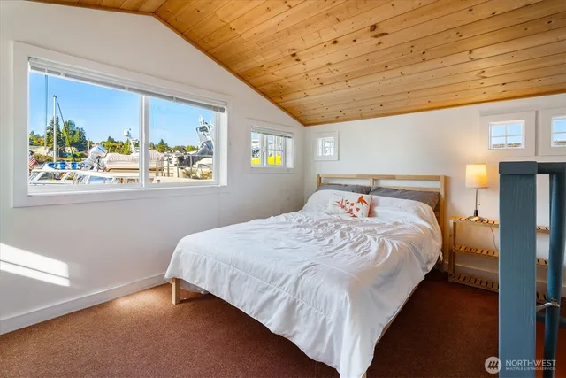 a bedroom with a large bed and a window