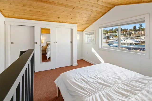 a bed sitting in a bedroom next to a window