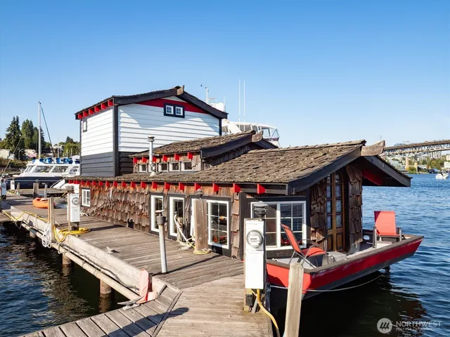 a view of a chairs and table on the deck in front of house
