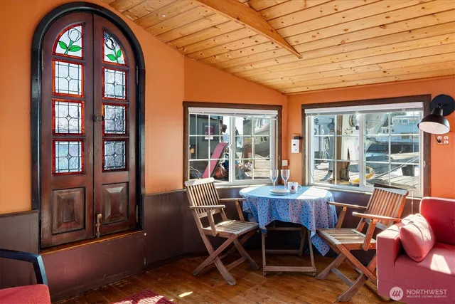 a dining room with wooden floor and furniture