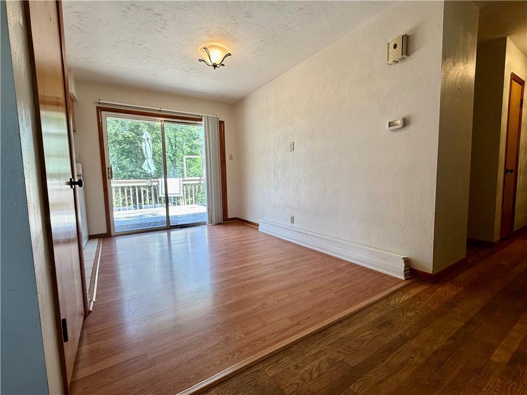121 Kemar Drive Butler, PA 16002 - Photo 10 of 31 a view of an empty room with wooden floor and a window