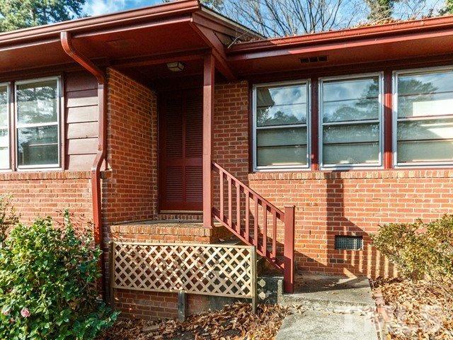 3513 Brook Drive Raleigh, NC 27609 - Photo 2 of 30 a front view of a house with a garden