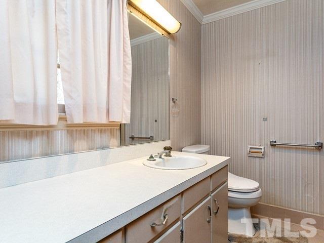3513 Brook Drive Raleigh, NC 27609 - Photo 14 of 30 a bathroom with a sink a toilet and a mirror