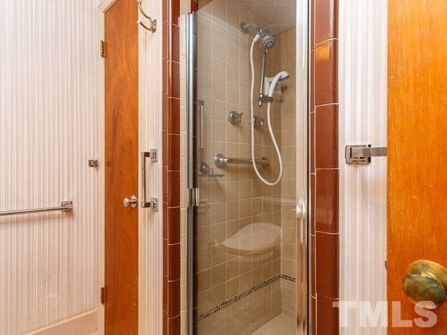 3513 Brook Drive Raleigh, NC 27609 - Photo 15 of 30 a bathroom with a glass shower door