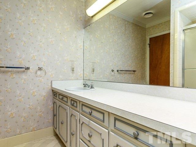 3513 Brook Drive Raleigh, NC 27609 - Photo 17 of 30 a bathroom with a sink and a mirror