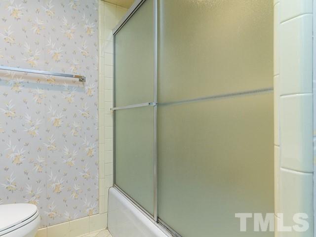 3513 Brook Drive Raleigh, NC 27609 - Photo 18 of 30 a bathroom with a shower and a toilet