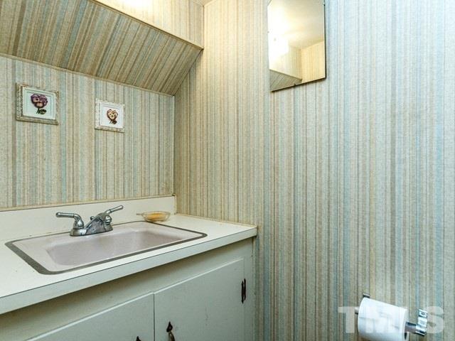 3513 Brook Drive Raleigh, NC 27609 - Photo 23 of 30 a bathroom with a sink and a mirror