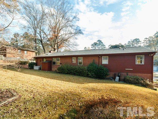 3513 Brook Drive Raleigh, NC 27609 - Photo 27 of 30 a view of a yard in front of a brick house with many windows