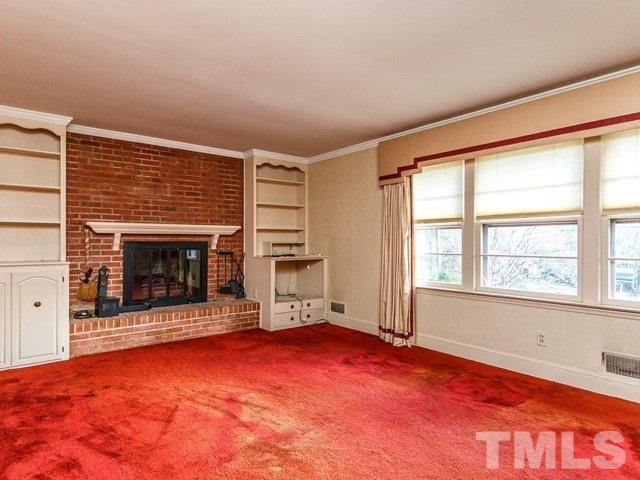 3513 Brook Drive Raleigh, NC 27609 - Photo 4 of 30 an empty room with windows and fireplace