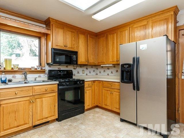 3513 Brook Drive Raleigh, NC 27609 - Photo 8 of 30 a kitchen with stainless steel appliances granite countertop a refrigerator sink and stove
