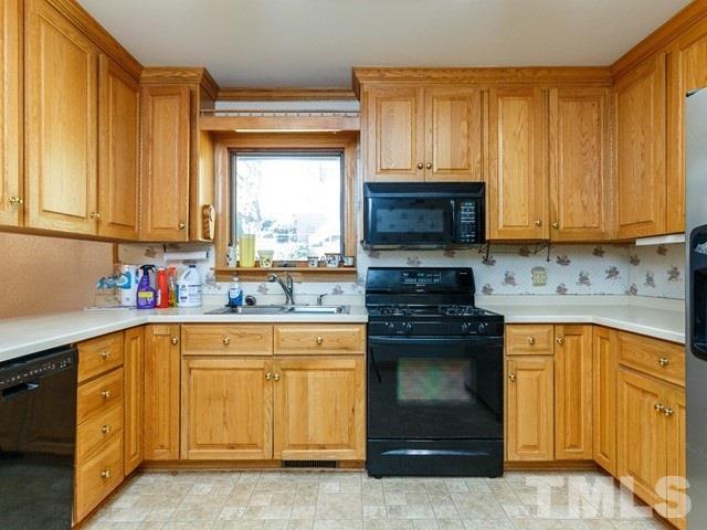 3513 Brook Drive Raleigh, NC 27609 - Photo 10 of 30 a kitchen with stainless steel appliances granite countertop a stove sink and cabinets