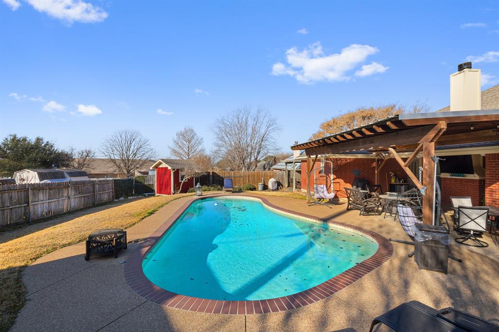 1701 Oakmeadow Drive Decatur, TX 76234 - Photo 35 of 39 a view of a swimming pool with an outdoor seating and a kitchen