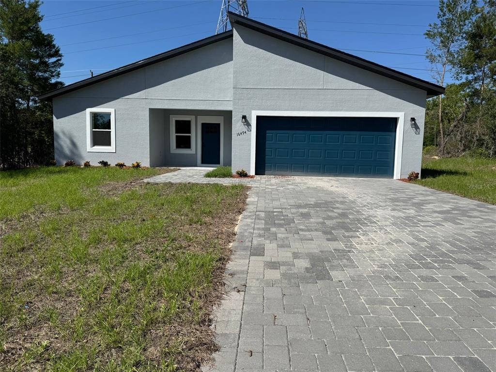 16494 Southwest 54th Ct Road Ocala, FL 34473 - Photo 1 of 1 a front view of a house with a yard and garage
