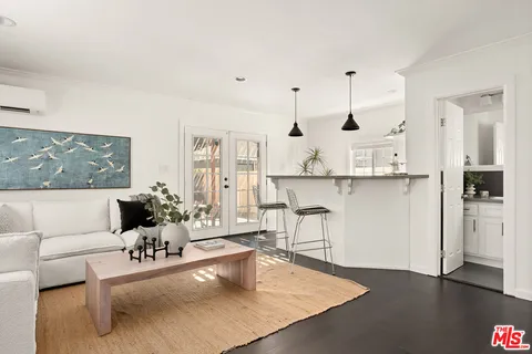a living room with furniture and kitchen view