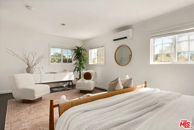 a bedroom with bed and window