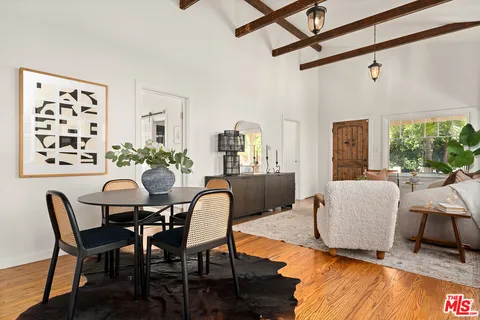 a dining room with furniture and wooden floor