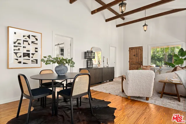 a dining room with furniture and wooden floor