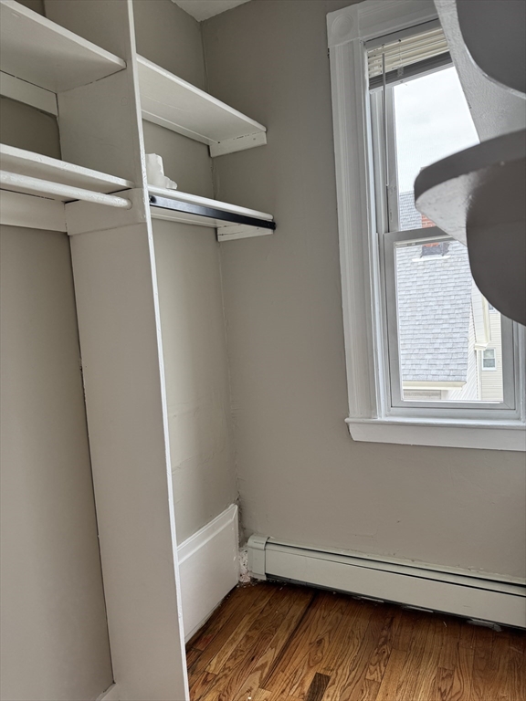 56 Estes Street, Unit 5 Lynn, MA 01902 - Photo 7 of 11 a view of closet with wooden floor and fan