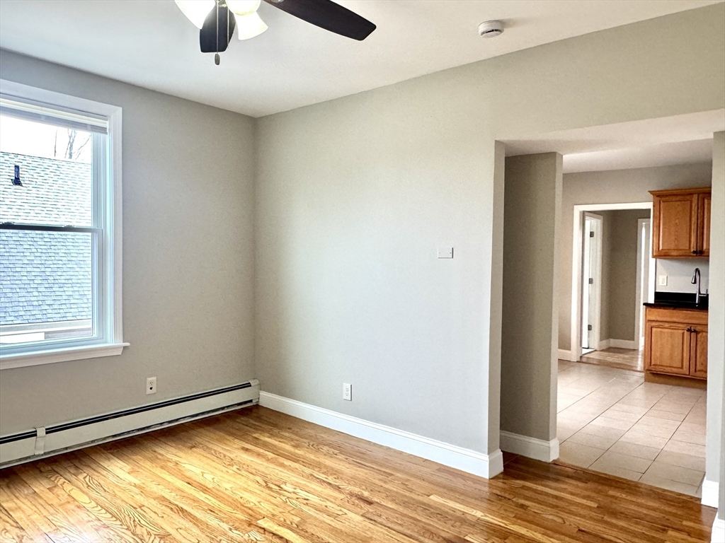56 Estes Street, Unit 5 Lynn, MA 01902 - Photo 8 of 11 a view of empty room with wooden floor