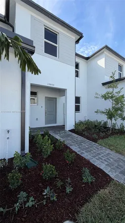 a view of a house with a yard and plants