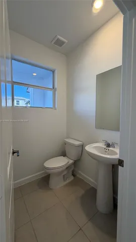 a bathroom with a sink a toilet and mirror
