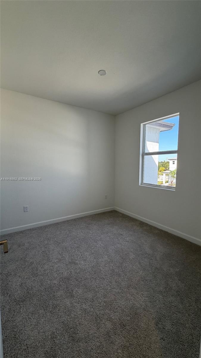 15600 Southwest 276th Terrace Homestead, FL 33031 - Photo 9 of 15 an empty room with a window