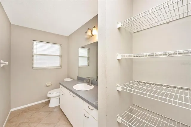 a bathroom with a granite countertop sink toilet a mirror and shower