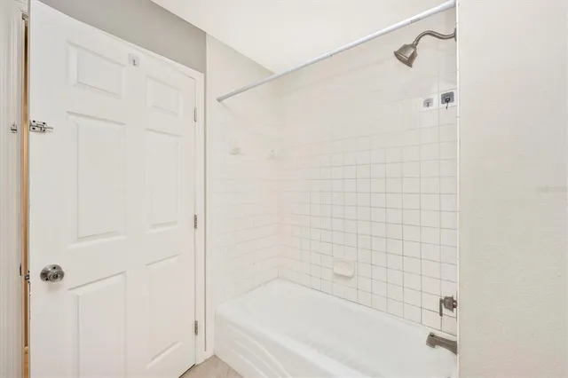 a bathroom with a shower and a bath tub
