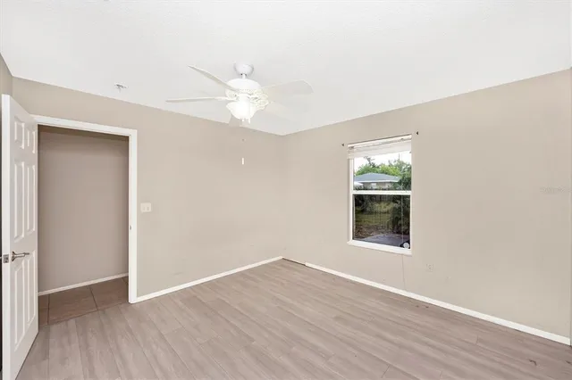 wooden floor in an empty room with a window