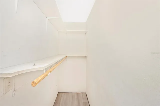 a view of walk in closet with clothes