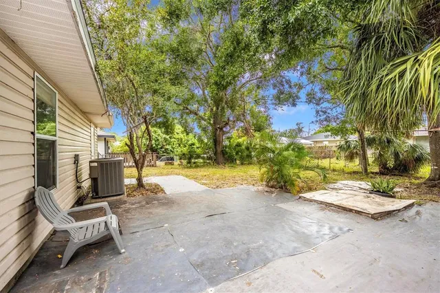 a view of backyard with swimming pool and sitting area